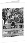 Smiling happy family mother father toddler boy portrait by farm fence by Anonymous
