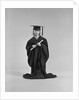 Girl wearing graduation cap gown holding diploma by Anonymous