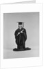 Girl wearing graduation cap gown holding diploma by Anonymous