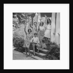 Family group of people standing on steps of house waving by Anonymous