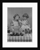 Two twin girls eating making candy apples in kitchen by Anonymous