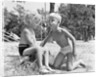 Blonde boy girl wearing bathing suits blowing on a pinwheel toy summer by Anonymous