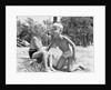 Blonde boy girl wearing bathing suits blowing on a pinwheel toy summer by Anonymous