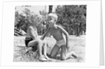 Blonde boy girl wearing bathing suits blowing on a pinwheel toy summer by Anonymous