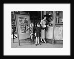 Mother and 2 children buying tickets to movie matinee boy wearing cowboy costume by Anonymous