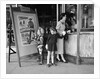 Mother and 2 children buying tickets to movie matinee boy wearing cowboy costume by Anonymous