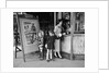 Mother and 2 children buying tickets to movie matinee boy wearing cowboy costume by Anonymous