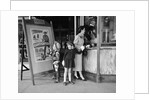 Mother and 2 children buying tickets to movie matinee boy wearing cowboy costume by Anonymous