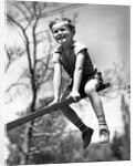 Boy on seesaw smiling by Anonymous
