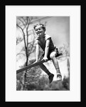 Boy on seesaw smiling by Anonymous
