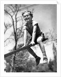 Boy on seesaw smiling by Anonymous