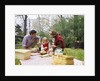Family mother father girl spring picnic on checkered tablecloth by Anonymous