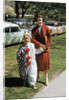 Mother with son dressed in clown suit outdoors by Anonymous