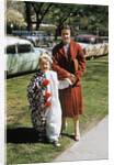 Mother with son dressed in clown suit outdoors by Anonymous