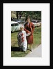 Mother with son dressed in clown suit outdoors by Anonymous