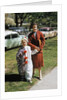Mother with son dressed in clown suit outdoors by Anonymous