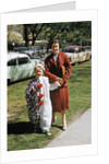 Mother with son dressed in clown suit outdoors by Anonymous