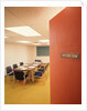 Conference room interior with table chairs chalkboard open door ajar by Anonymous