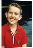 Portrait young boy in red shirt smiling by Anonymous