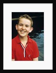 Portrait young boy in red shirt smiling by Anonymous