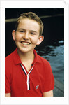 Portrait young boy in red shirt smiling by Anonymous
