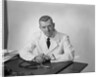 Portrait male doctor sitting at desk serious expression by Anonymous