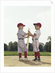 Two boys holding baseball bat little league uniforms by Anonymous