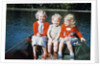 Boy and two girls in red sweaters sitting in back of rowboat by Anonymous