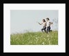 Young teen couple boy girl running field wildflowers by Anonymous