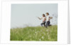 Young teen couple boy girl running field wildflowers by Anonymous