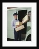 Delivery truck driver holding packages by Anonymous
