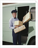 Delivery truck driver holding packages by Anonymous