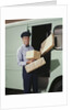 Delivery truck driver holding packages by Anonymous
