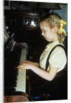 Little blond girl playing practicing the piano by Anonymous
