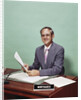 Smiling man at desk holding papers with mortgage officer sign looking at camera by Anonymous