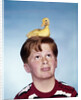 Boy with baby duckling sitting on top of his head by Anonymous