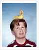 Boy with baby duckling sitting on top of his head by Anonymous