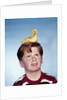 Boy with baby duckling sitting on top of his head by Anonymous