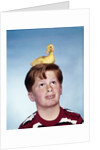 Boy with baby duckling sitting on top of his head by Anonymous