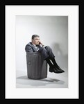 Sad man in business suit sitting in trash garbage can by Anonymous