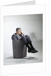 Sad man in business suit sitting in trash garbage can by Anonymous