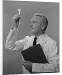 Man scientist studying test tube by Anonymous
