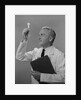 Man scientist studying test tube by Anonymous