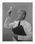 Man scientist studying test tube by Anonymous
