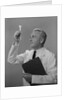 Man scientist studying test tube by Anonymous
