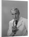 Male doctor holding stethoscope by Anonymous