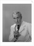 Male doctor holding stethoscope by Anonymous