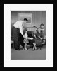 Family living room woman mother getting surprise gift from children daughter son husband by Anonymous