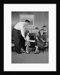 Family living room woman mother getting surprise gift from children daughter son husband by Anonymous