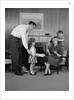 Family living room woman mother getting surprise gift from children daughter son husband by Anonymous